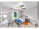 Sunlit bedroom with a ceiling fan and a large window view at 11 Locust Trak, Ocala, FL 34472