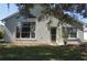 Backyard featuring large windows, a glass door, and a well-kept lawn at 11091 Sw 73Rd Ct, Ocala, FL 34476