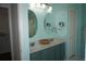Bathroom vanity with dual sinks, oval mirrors, and ample storage at 11091 Sw 73Rd Ct, Ocala, FL 34476