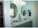 Bright bathroom with dual sinks, a shower, and walk-in closet at 11091 Sw 73Rd Ct, Ocala, FL 34476