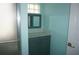 Bathroom featuring a shower, vanity with cabinet and a framed mirror at 11091 Sw 73Rd Ct, Ocala, FL 34476