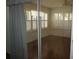 Bedroom featuring hardwood floors, a ceiling fan, and windows with white shutter-style blinds at 11091 Sw 73Rd Ct, Ocala, FL 34476