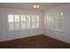 Bright bedroom with hardwood floors, a ceiling fan, and plantation shutters on the windows at 11091 Sw 73Rd Ct, Ocala, FL 34476