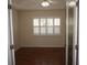 Bright room with wood floors, a ceiling fan, and a window with plantation shutters at 11091 Sw 73Rd Ct, Ocala, FL 34476