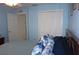 Bedroom featuring blue walls, a closet, and a ceiling fan with a window and white shutters at 11091 Sw 73Rd Ct, Ocala, FL 34476