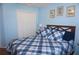 Bedroom with blue walls, closet, and a bed with a blue comforter at 11091 Sw 73Rd Ct, Ocala, FL 34476