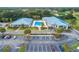 Aerial view of the community clubhouse featuring a large pool, covered seating, parking and manicured landscaping at 11091 Sw 73Rd Ct, Ocala, FL 34476