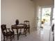 Cozy dining area features a classic table set near bright, glass double doors and neutral wall paint at 11091 Sw 73Rd Ct, Ocala, FL 34476