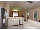 Open kitchen featuring stainless appliances and white cabinets, with a view to the living area at 11091 Sw 73Rd Ct, Ocala, FL 34476