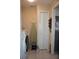 Laundry room with washer, ironing board, and door at 11091 Sw 73Rd Ct, Ocala, FL 34476