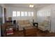 Inviting living room featuring natural light from plantation shutters and hardwood floors at 11091 Sw 73Rd Ct, Ocala, FL 34476