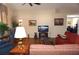 Bright living room featuring hardwood floors, a ceiling fan, and seamless flow to the office at 11091 Sw 73Rd Ct, Ocala, FL 34476