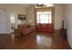 Inviting living room with high ceilings, large window, and laminate wood flooring at 11091 Sw 73Rd Ct, Ocala, FL 34476