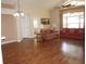 Spacious living room with high ceilings, fan, large window, and laminate wood flooring at 11091 Sw 73Rd Ct, Ocala, FL 34476