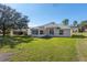 Well-maintained backyard featuring lush green grass and mature trees at 11625 Sw 71St Cir, Ocala, FL 34476