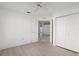 Bedroom with light wood-look flooring, closet, and bright natural lighting at 11625 Sw 71St Cir, Ocala, FL 34476