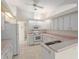 Bright kitchen features white cabinets, pink countertops and appliances at 11625 Sw 71St Cir, Ocala, FL 34476