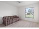 Bright living room with a ceiling fan, a large window, and light wood-look flooring at 11625 Sw 71St Cir, Ocala, FL 34476