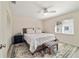 Comfortable bedroom featuring soft carpeting, a ceiling fan, and large window at 165 Ne 43Rd Ave, Ocala, FL 34470