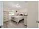 This bedroom features a dresser, window, and bed with white furniture and gray flooring at 165 Ne 43Rd Ave, Ocala, FL 34470