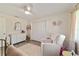 Cozy bedroom with natural light, ceiling fan, white closet and accent furniture at 165 Ne 43Rd Ave, Ocala, FL 34470