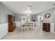 A dining room with hardwood floors, light gray walls, elegant furnishings, and easy kitchen access at 165 Ne 43Rd Ave, Ocala, FL 34470