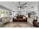 A living room with hardwood floors, elegant furnishings, light gray walls, and a ceiling fan at 165 Ne 43Rd Ave, Ocala, FL 34470