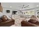 A living room with hardwood floors, elegant furnishings, light gray walls, and a ceiling fan at 165 Ne 43Rd Ave, Ocala, FL 34470