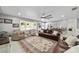 A living room with hardwood floors, elegant furnishings, light gray walls, and a ceiling fan at 165 Ne 43Rd Ave, Ocala, FL 34470