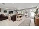 An open concept living room with light gray walls, a ceiling fan, hardwood floors, and elegant furnishings at 165 Ne 43Rd Ave, Ocala, FL 34470