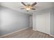 Bedroom featuring wood look flooring, neutral paint, ceiling fan and a double closet at 1681 Nw 44Th Ct Rd, Ocala, FL 34482