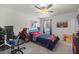 Bedroom setup for gaming, features ceiling fan, window and themed decor at 1681 Nw 44Th Ct Rd, Ocala, FL 34482