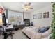 Bright bedroom featuring a large window, ceiling fan and a desk at 1681 Nw 44Th Ct Rd, Ocala, FL 34482