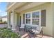 Inviting front porch with outdoor seating, brick pavers, and shade shutters on the home's front windows at 1681 Nw 44Th Ct Rd, Ocala, FL 34482