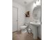 Half bathroom with a toilet, sink, and decorative storage cabinet at 1681 Nw 44Th Ct Rd, Ocala, FL 34482