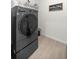 Modern laundry room with front load washer/dryer and stylish tile flooring at 1681 Nw 44Th Ct Rd, Ocala, FL 34482