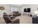 Living room with theater seating, light-colored wood floors, and large bright windows at 1681 Nw 44Th Ct Rd, Ocala, FL 34482