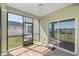 Cozy screened porch with brick flooring, ceiling fan, and views of the backyard at 1681 Nw 44Th Ct Rd, Ocala, FL 34482