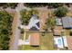 Aerial view of property showcasing the roof with solar panels, backyard, nearby pool, and neighborhood at 18 Fir Trail Pass, Ocala, FL 34472