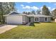 Beautifully maintained front lawn with a modern home design, complete with a two-car garage at 206 Emerald Rd, Ocala, FL 34472