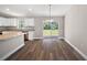 Modern kitchen with stainless steel appliances, granite countertops, white cabinets, and hardwood floors at 206 Emerald Rd, Ocala, FL 34472