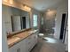Bathroom featuring double sinks, granite countertops and a glass enclosed shower at 2150 Nw 23Rd Loop, Ocala, FL 34475