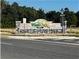 Community entrance sign for 'West Oak' with stone accents, suggesting a welcoming and well-maintained neighborhood at 2150 Nw 23Rd Loop, Ocala, FL 34475