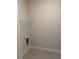 This is a laundry room with tile floors, base trim, neutral walls, and a wire shelf at 2150 Nw 23Rd Loop, Ocala, FL 34475