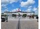 The World Equestrian Center's elegant main building with flags and a horse statue on a beautiful, sunny day at 2150 Nw 23Rd Loop, Ocala, FL 34475