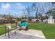 Backyard patio seating area features grill and outdoor shed with large trees providing shade at 21615 Sw Raintree St, Dunnellon, FL 34431