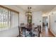 Dining room displaying a grandfather clock, round table, and natural light from a window at 21615 Sw Raintree St, Dunnellon, FL 34431