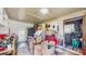 Bright garage space with ample storage featuring a white door and access to the backyard at 21615 Sw Raintree St, Dunnellon, FL 34431