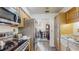 Kitchen showcasing stainless steel appliances and wooden cabinets with stone countertops at 21615 Sw Raintree St, Dunnellon, FL 34431