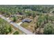 Aerial view of a home with a long driveway, a well-manicured lawn, and lush surrounding trees at 22242 Sw Marine Blvd, Dunnellon, FL 34431